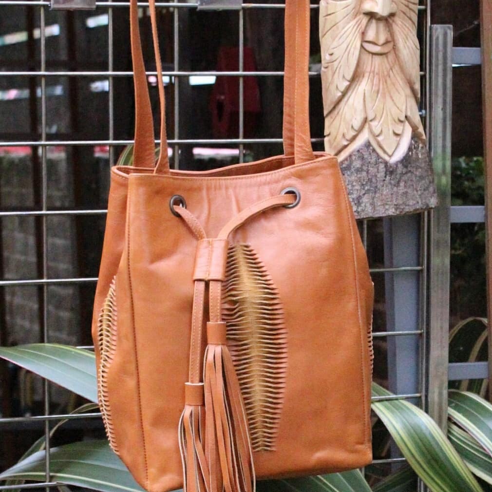 Brown leather bag with cut and tassel detail