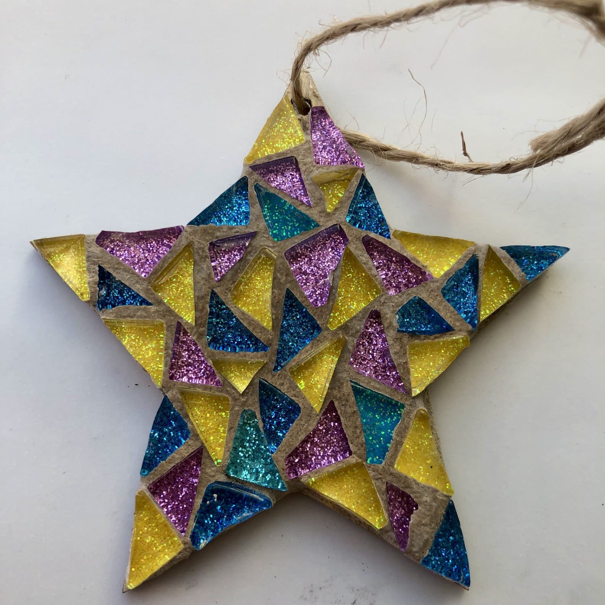 Small star mosaic with blue, yellow and pink colours with string