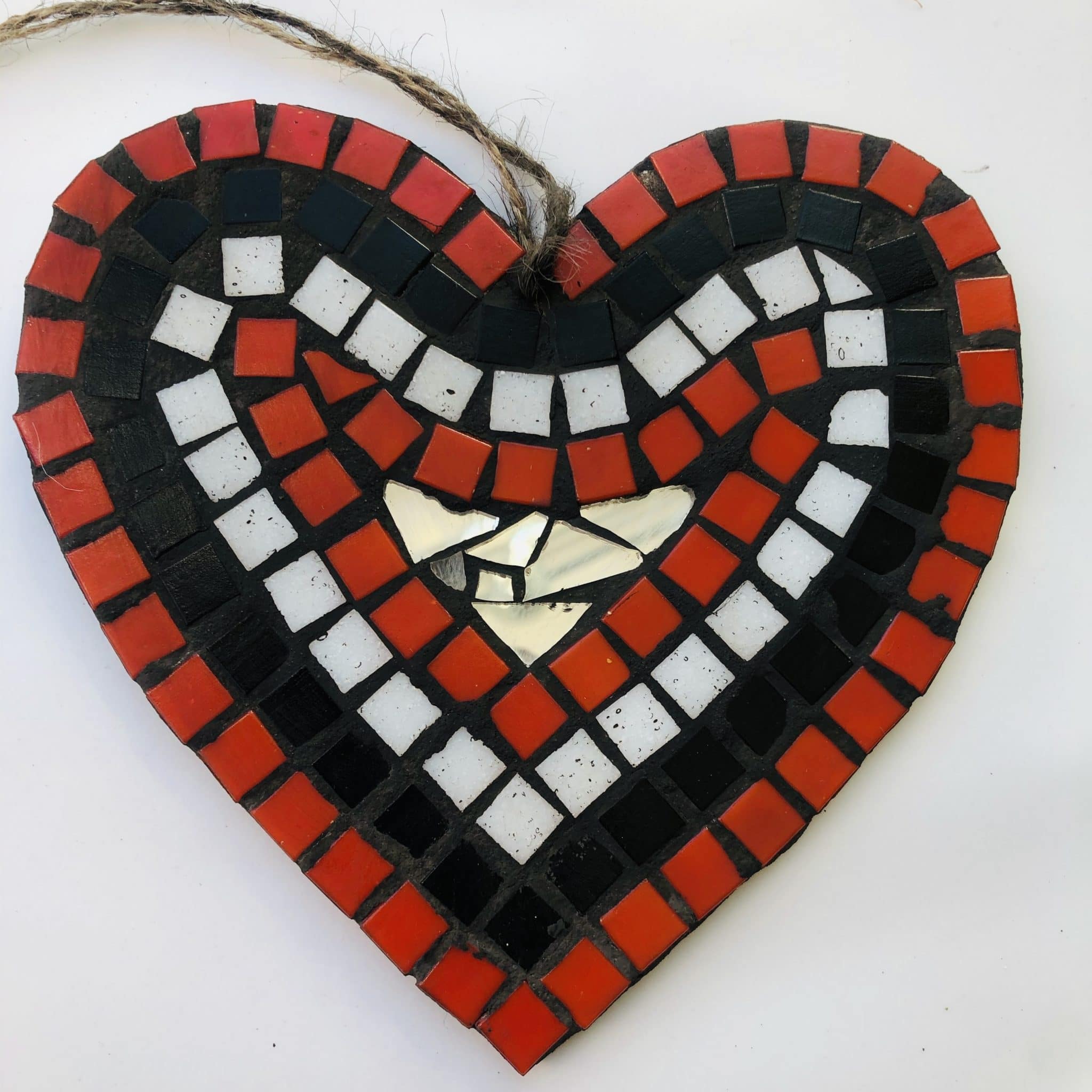 Small heart shaped mosaic with black, red, white, and gold colours